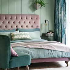 bedroom with light green wall and pink headboard