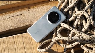 Honor Magic7 Pro phone on wooden planks next to some curled rope