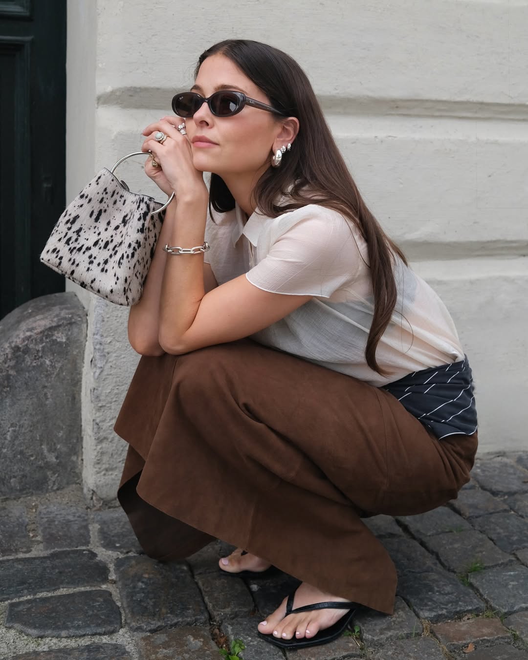 @thealiceedit wears brown skirt, sheer top and Dalmatian print bag