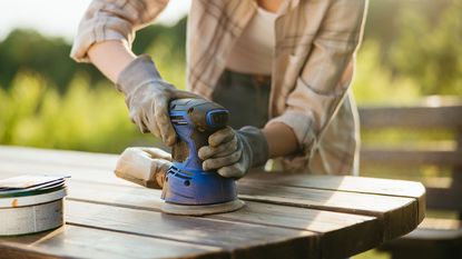 sanding outdoor furniture with a sander