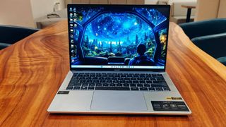Sliver Acer Swift Go 14 laptop on a wooden table