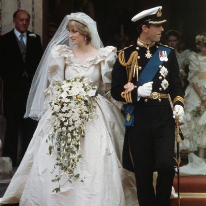 Princess Diana on her wedding day wearing a long white gown and standing with King Charles, who is wearing military uniform