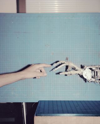 Human finger touching robotic finger