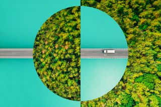 Business sustainability concept art image featuring a vehicle driving on a road with forested area ahead