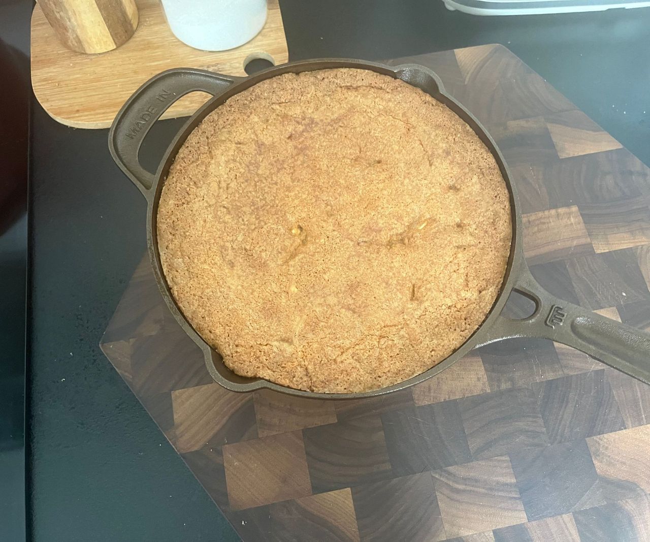 A small bronze colored cast-iron skillet with a skillet cookie inside