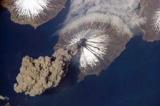 The erupting Cleveland Volcano in Alaska's Aleutian Islands, captured by International Space Station astronauts in 2006. Earth has a "secondary atmosphere" produced in part by volcanoes.