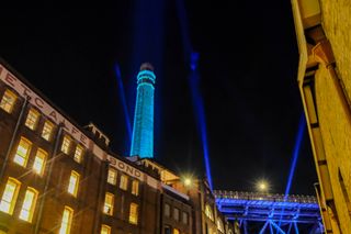A tall chimney lit with blue light during Vivid Sydney 2022