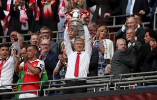 Arsene Wenger hoists the trophy after winning the FA Cup as Arsenal manager for a seventh time in 2017