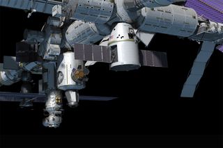A still from an animated video shows an artist's impression of SpaceX's Dragon capsule at the International Space Station.