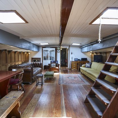 lounge with wooden flooring and sofa