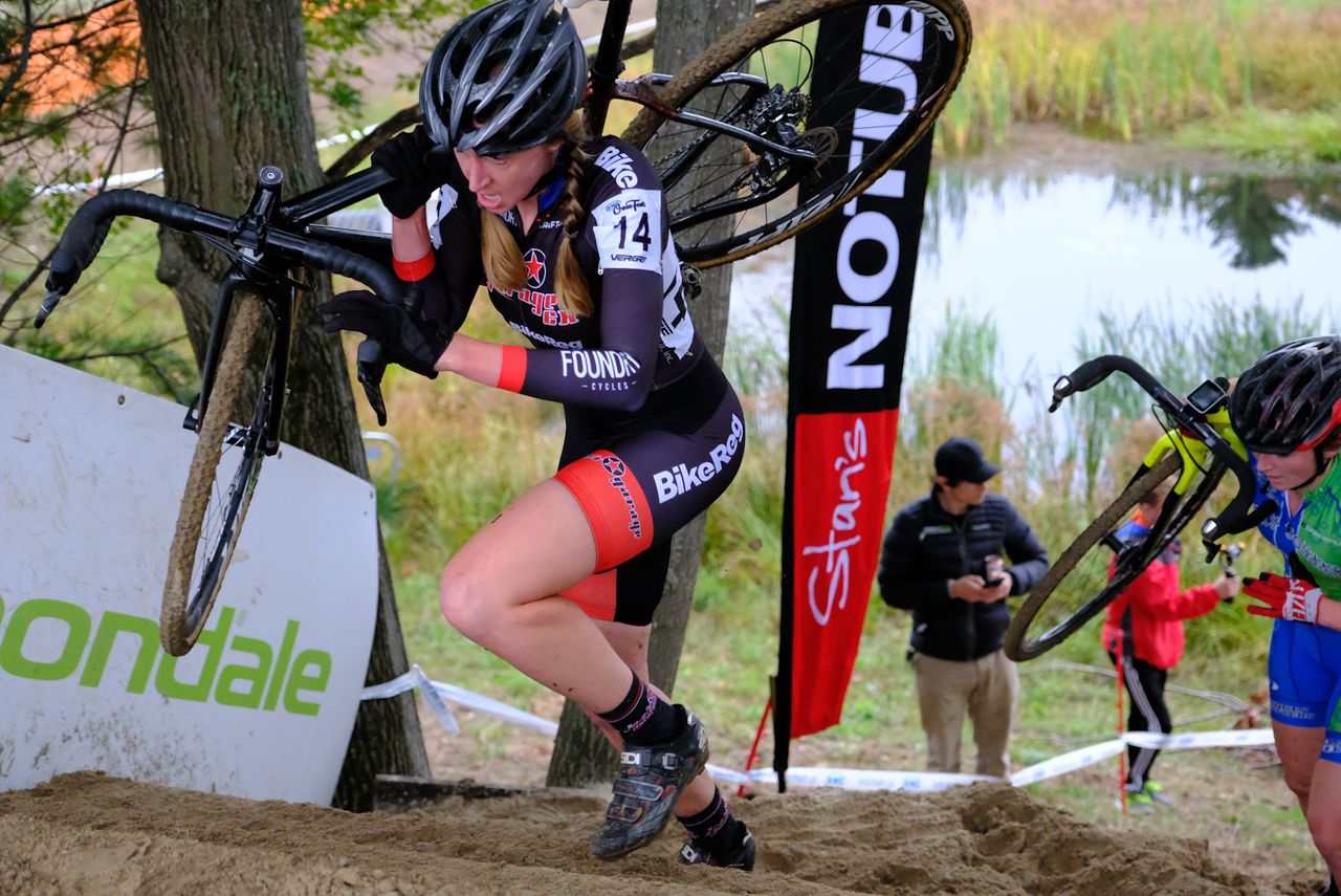 Kate Lysakowski (Joe&rsquo;s Garage) shouldering her bike at the stairs