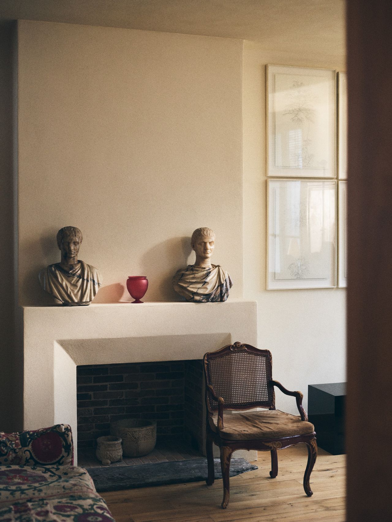 A series of products from Zara Home designed by NYC's Colin King, including red lacquered nesting tables, a red vessel, an egg-shaped lamp, and a basked woven in brass.