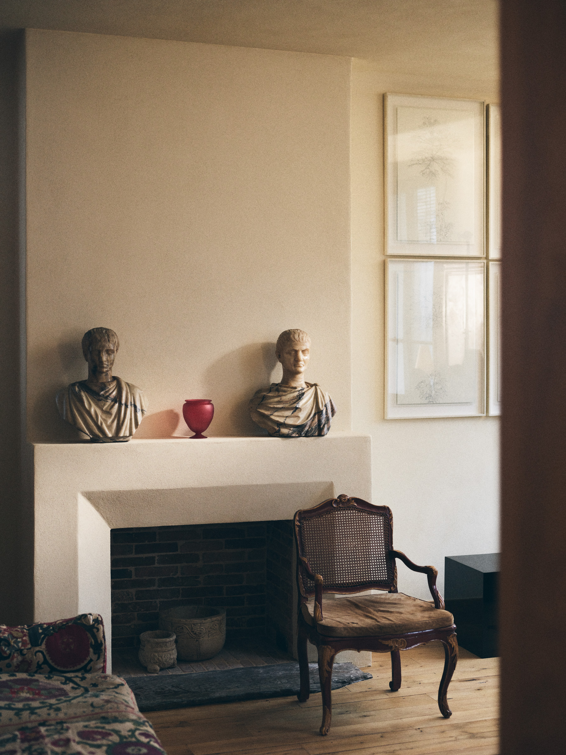 A series of products from Zara Home designed by NYC's Colin King, including red lacquered nesting tables, a red vessel, an egg-shaped lamp, and a basked woven in brass.  