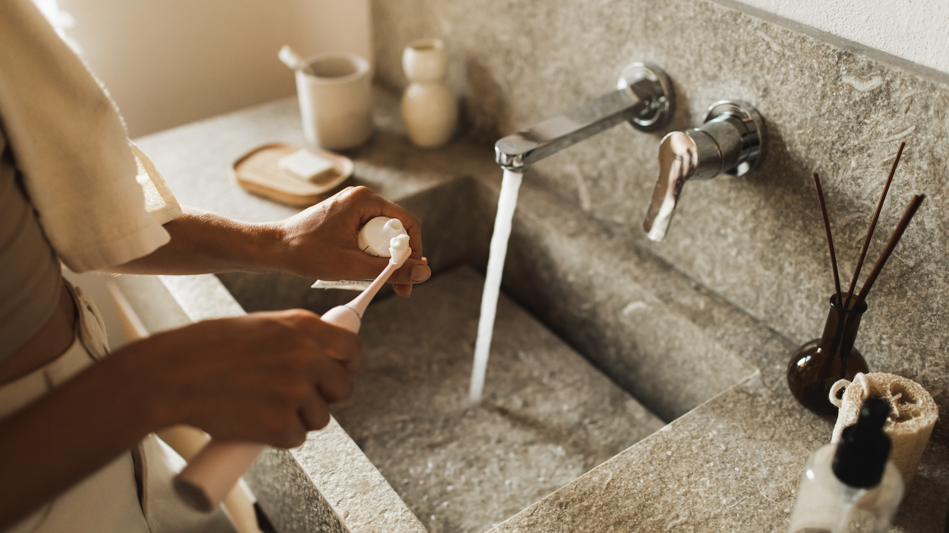 Woman brushing teeth in bathroom
