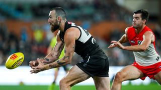 Port Adelaide's Charlie Dixon handballs in a match against Sydney ahead of the AFL preliminary final 2024 live stream.