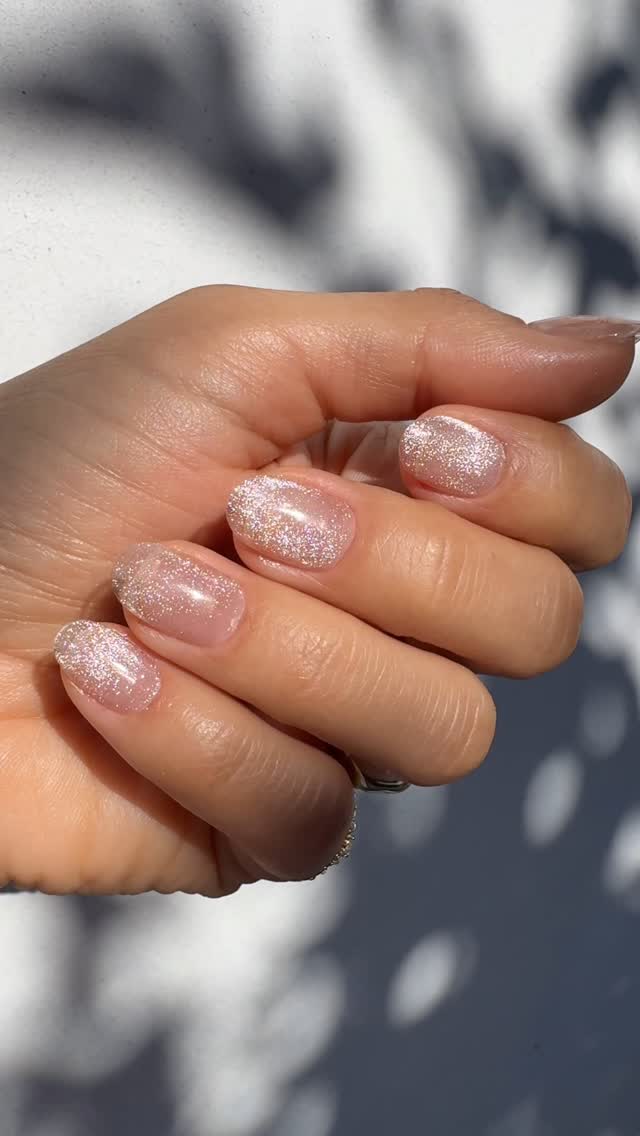 A close-up of a sheer cat-eye manicure