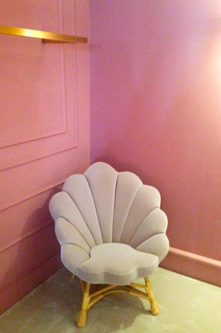 Light pink chair in front of a pink wall