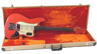 A 1962 Fender Bass VI in Shell Pink sits in its case.