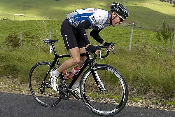 Englishman Ben Greenwood rides for the GHD-Burnie team during this tour and grimaces his way to the top of the climb at Gunns Plains.