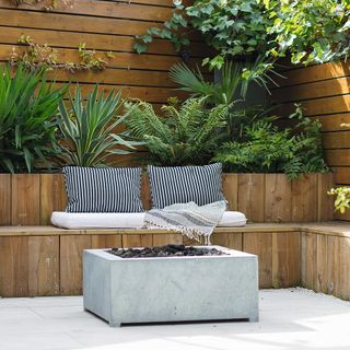 garden area with garden seating area and cushions with plant and shrubs