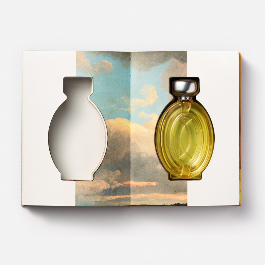 a book cutout with a bottle of perfume inside