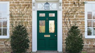 Front door painted in Graham & Brown forest green paint to illlustrate the forest green color trend