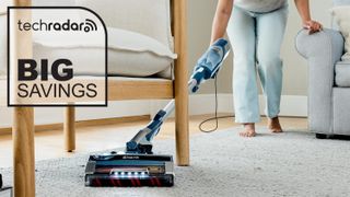 Person using Shark vacuum, with Big Savings graphic overlaid
