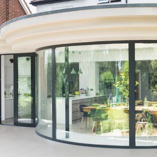 house extension kitchen and dinning area with curvy glass wall