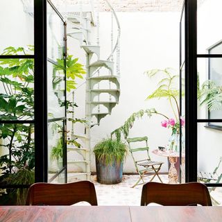 round staircase plants chair and bifold door