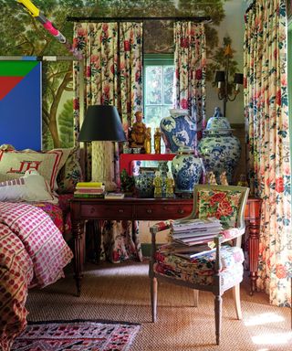 bedroom with floral curtains and armchair