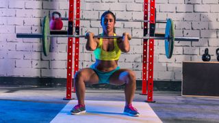 Woman performs barbell front squat