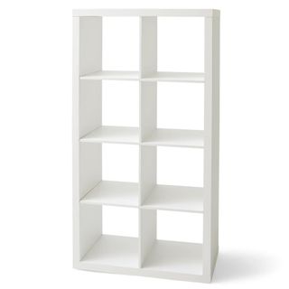 A white cube storage unit can be used as a bookshelf
