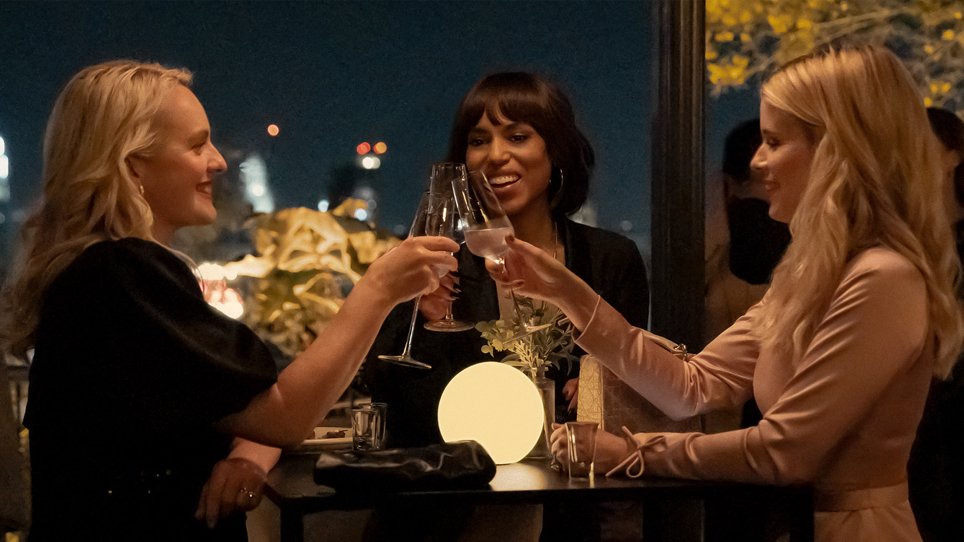 Elizabeth Moss, Kerry Washington and Kate Mara clink glasses in Apple TV's Imperfect Women