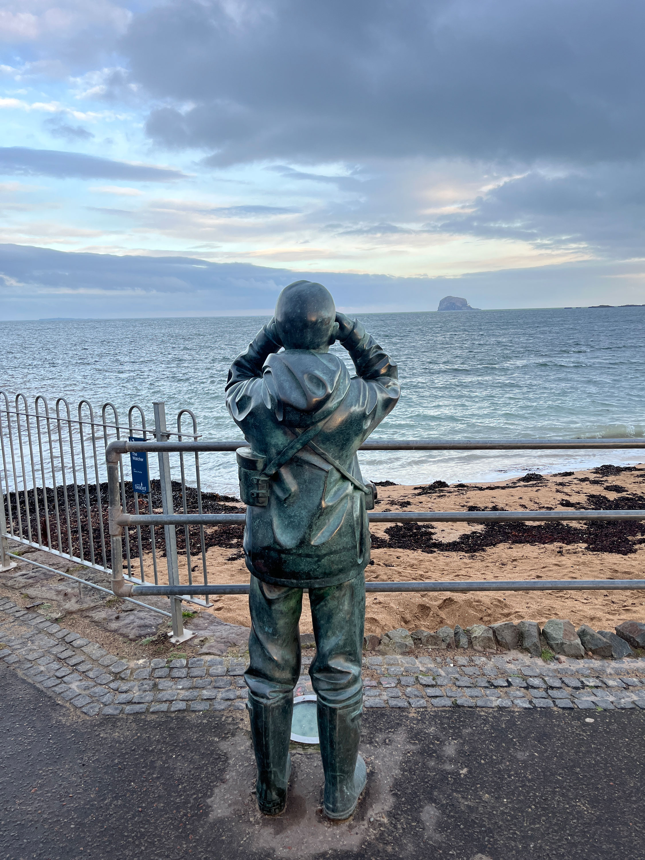 A statue of a birdwatcher looking out to the Bass Rock