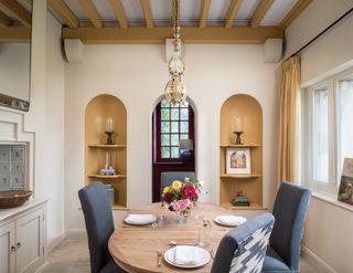 dining room with mustard yellow alcoves