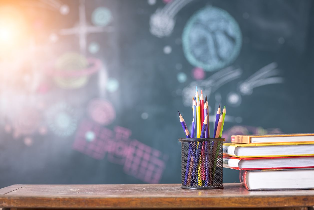 A chalk board and desk.