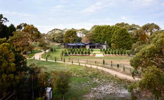 Australian farmhouse transformed into modern house seen from above among greenery