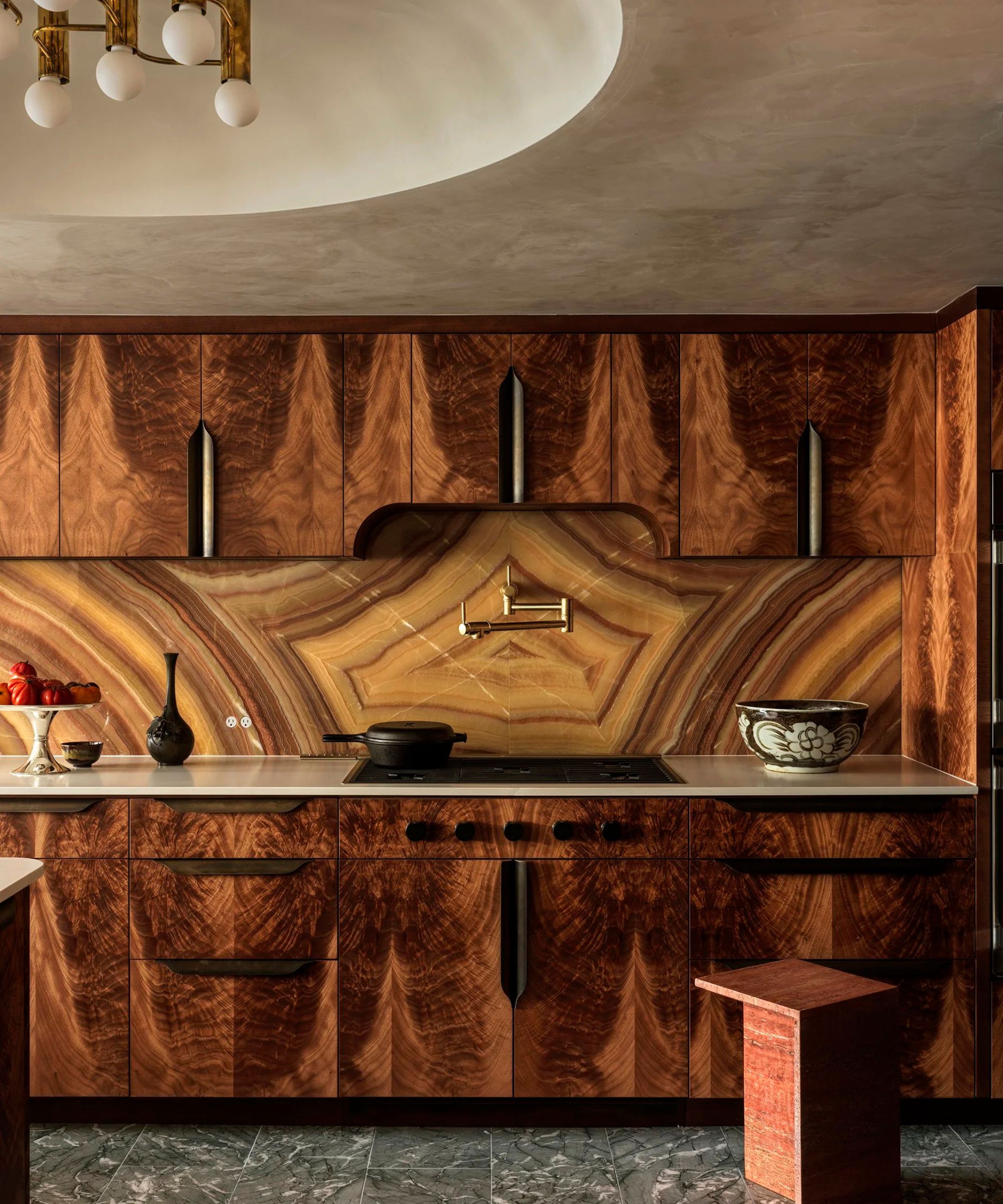 a kitchen with burl wood cabinetry, a vibrant marble backsplash, and a white ceiling