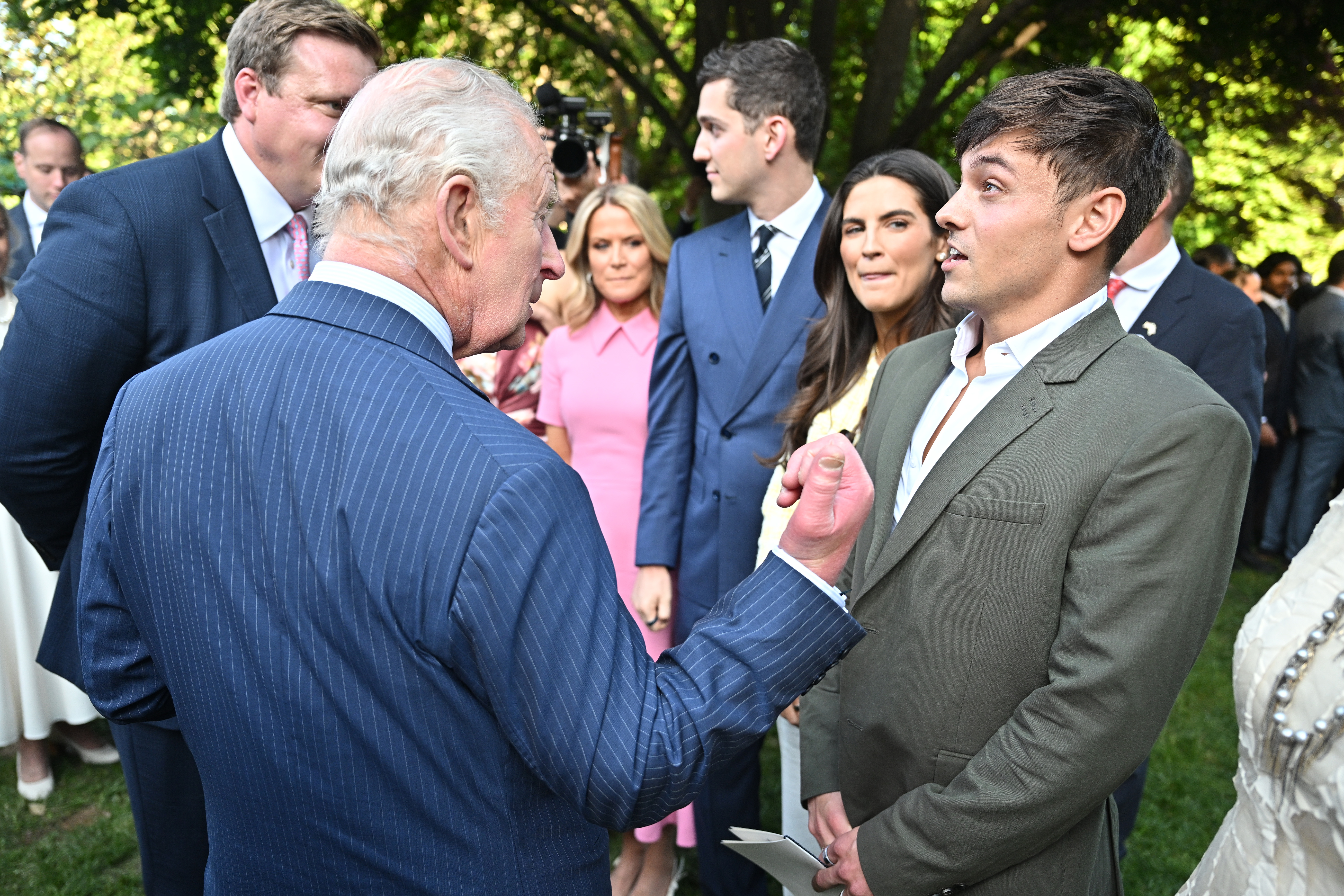 King Charles III chats with Tom Daley (R) and other guests during a Garden Party on April 27, 2026 at the White House in Washington, DC. (Photo by Samir Hussein/WireImage)