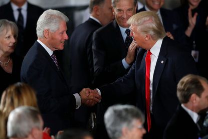 Bill Clinton and Donald Trump shake hands