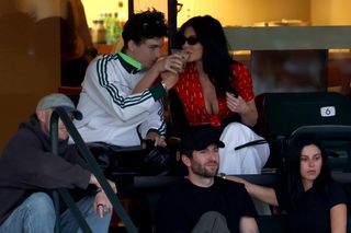 A photo of Kylie Jenner and Timothée Chalamet sipping drinks at the BNP Paribas Open.