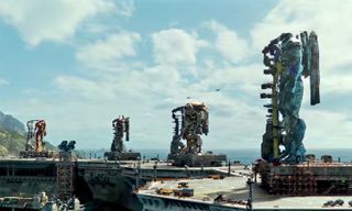 The giant Jaeger mechs of "Pacific Rim: Uprising" stand guard on gantries while wearing rocket engines on their backs in this still shot from the film's first full trailer.
