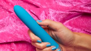 Woman holding a blue vibrator