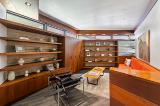 A home office with built in wall shelving