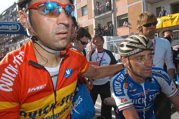 Juan Manuel Garate and Paolo Bettini get out of the finish area after Bettini's narrow stage loss
