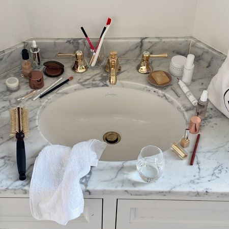 Photo of beauty products scattered on a sink