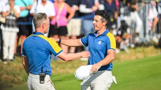Rory McIlroy of Team Europe hugs Captain Luke Donald after winning his match 3&1 during Sunday singles matches of the 2023 Ryder Cup