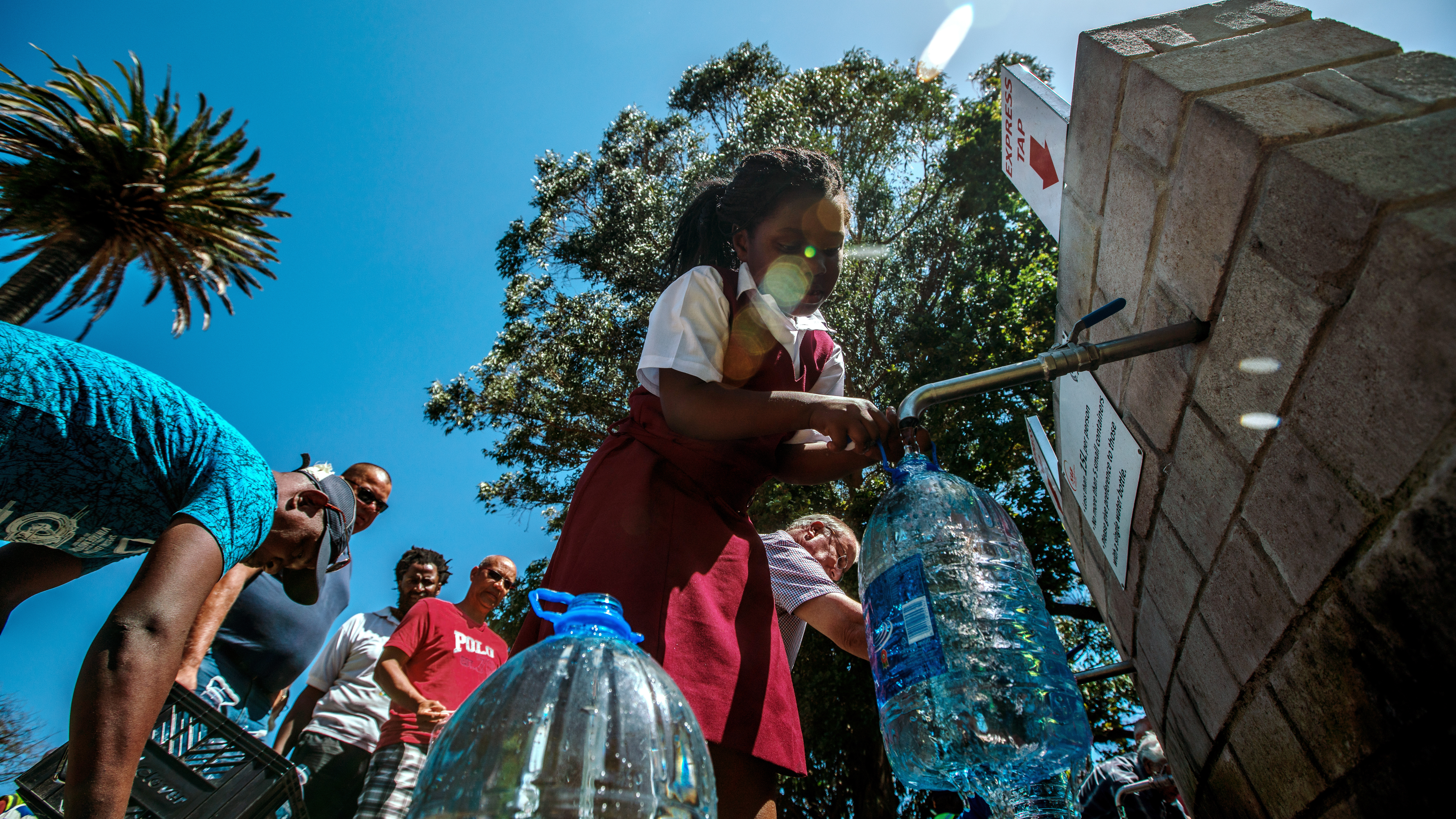 Image was created as a still grab taken from video.) Cape Town residents queue to refill water bottles at Newlands Brewery Spring Water Point on January 30, 2018 in Cape Town, South Africa.