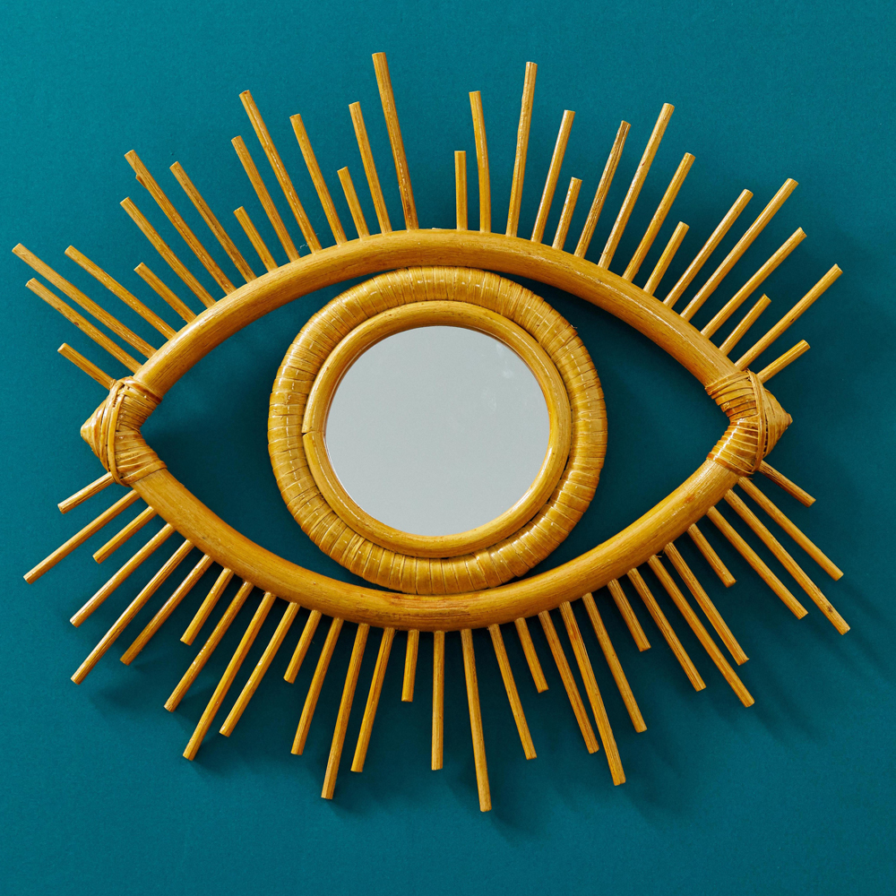 yellow coloured eye mirror on blue wall