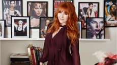 Charlotte Tilbury standing in front of pictures of her work -charlotte tilbury black friday
